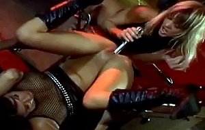 A metal dildo fucks two hot lesbians